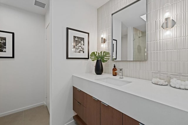 bathroom with walk in shower, tile patterned floors, vanity, and backsplash