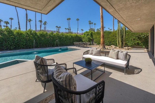 view of pool with an outdoor hangout area, pool water feature, and a patio area