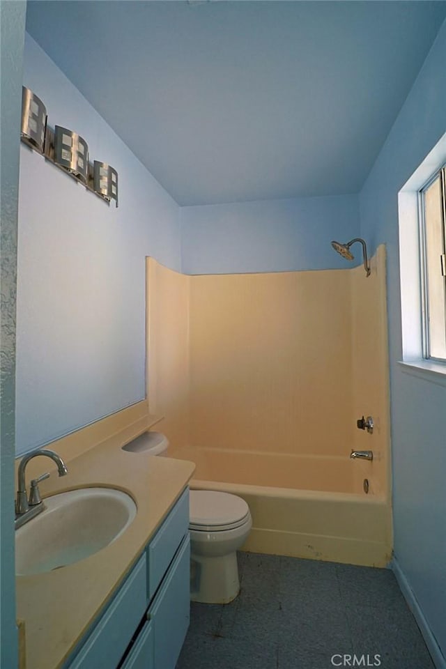 bathroom featuring toilet, shower / bathtub combination, baseboards, and vanity