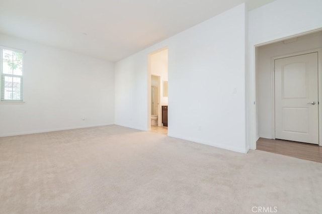 empty room featuring light colored carpet