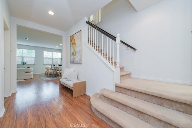 staircase with hardwood / wood-style flooring