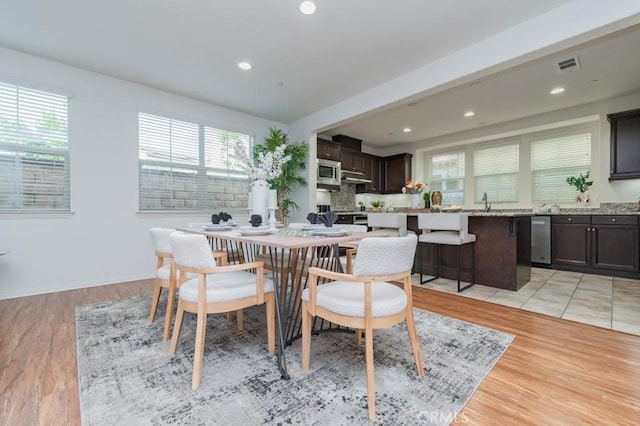 dining space with light hardwood / wood-style flooring and a wealth of natural light