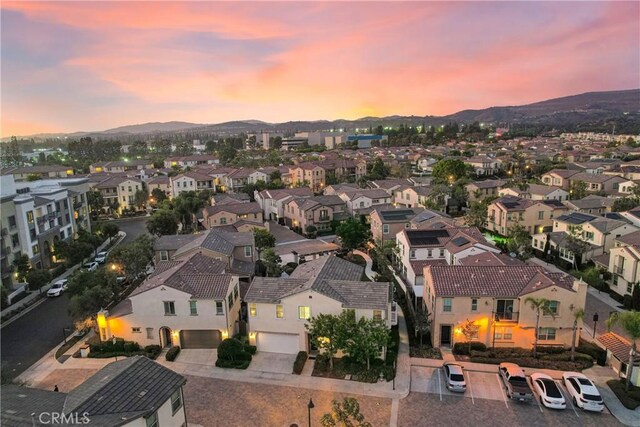 aerial view at dusk featuring a mountain view