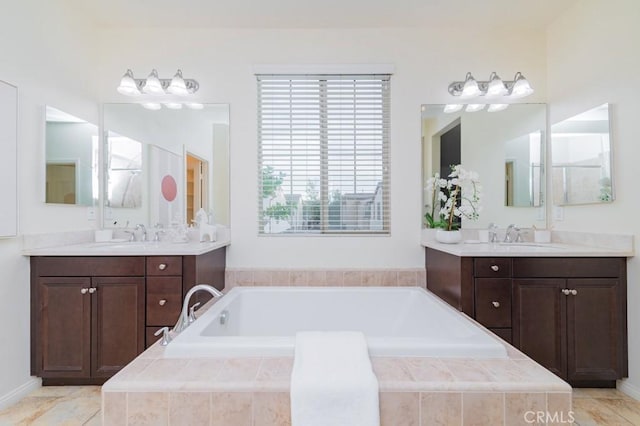 bathroom featuring vanity and tiled bath