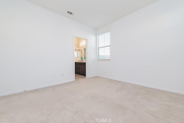 spare room with light colored carpet