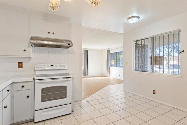 kitchen with white cabinetry, tile counters, white range with electric stovetop, and light tile patterned flooring