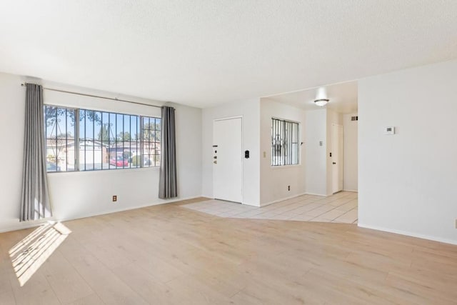 unfurnished room with light hardwood / wood-style floors