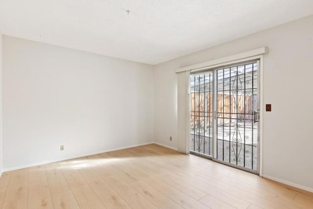 spare room featuring light hardwood / wood-style flooring