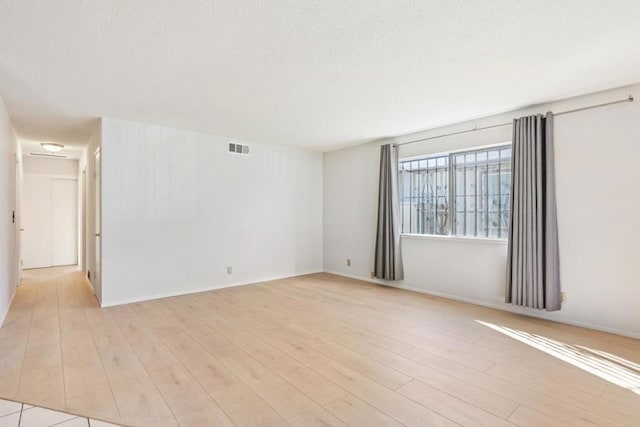 unfurnished room featuring light hardwood / wood-style floors