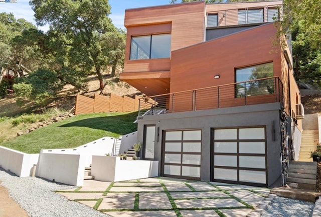 view of front facade with a garage and a balcony