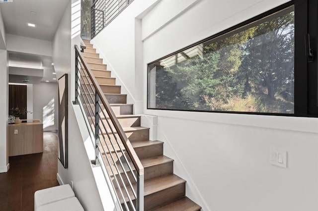 staircase with hardwood / wood-style floors