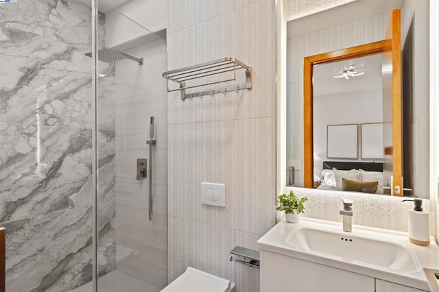 bathroom featuring vanity, tile walls, an enclosed shower, and toilet