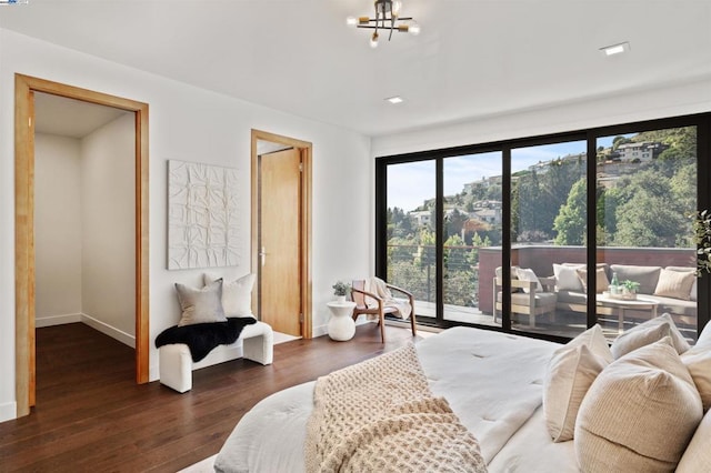 bedroom featuring dark hardwood / wood-style floors and a chandelier