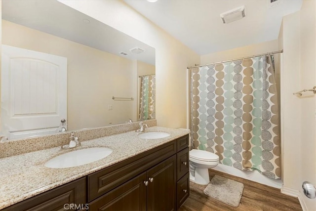 26605 Rose Bud Ln, Moreno Valley, CA 92555 - bathroom with a sink, toilet, double vanity, and wood finished floors