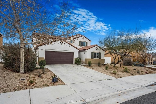 26605 Rose Bud Ln, Moreno Valley, CA 92555 - mediterranean / spanish-style house with a tile roof, a garage, driveway, and stucco siding