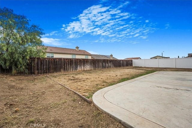 view of yard with a fenced backyard and a patio area