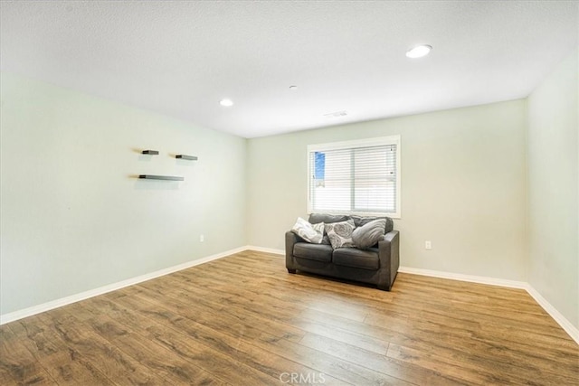 sitting room featuring recessed lighting, baseboards, and wood finished floors