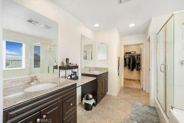 26605 Rose Bud Ln, Moreno Valley, CA 92555 - full bathroom with a stall shower, two vanities, a spacious closet, and tile patterned floors