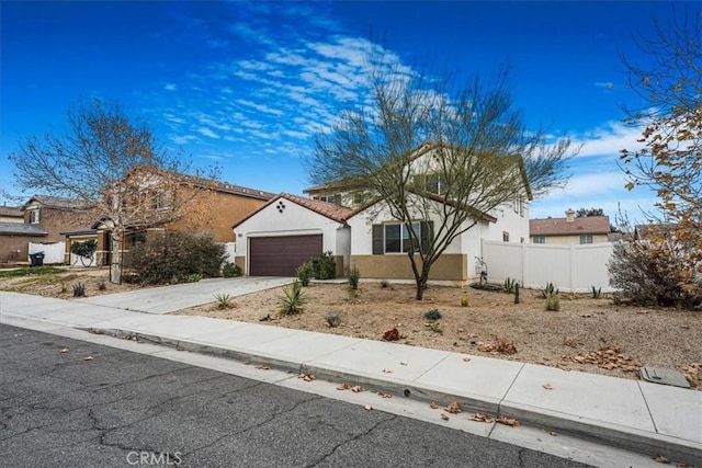26605 Rose Bud Ln, Moreno Valley, CA 92555 - view of front of property featuring concrete driveway, an attached garage, fence, and stucco siding