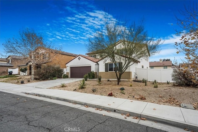 26605 Rose Bud Ln, Moreno Valley, CA 92555 - view of front of house featuring stucco siding, concrete driveway, and a garage