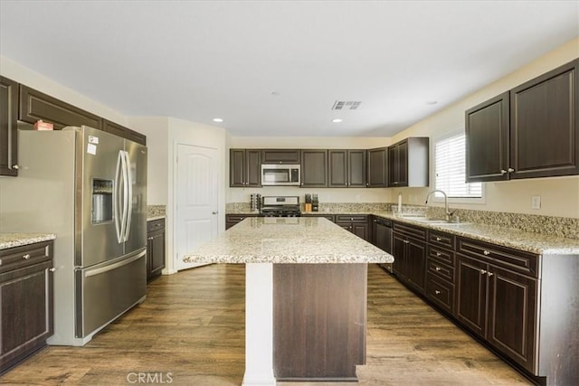 26605 Rose Bud Ln, Moreno Valley, CA 92555 - kitchen featuring appliances with stainless steel finishes, a center island, dark wood-style flooring, dark brown cabinets, and recessed lighting