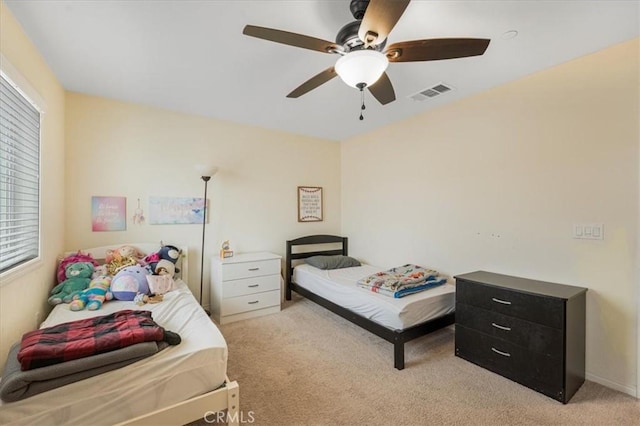 26605 Rose Bud Ln, Moreno Valley, CA 92555 - bedroom with light carpet, multiple windows, and a ceiling fan