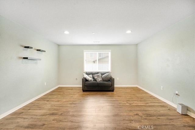 sitting room with recessed lighting, baseboards, and wood finished floors