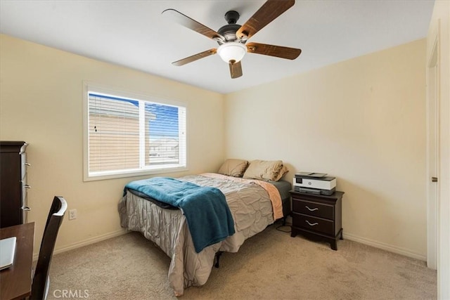 bedroom featuring a ceiling fan, light colored carpet, and baseboards