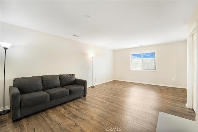 26605 Rose Bud Ln, Moreno Valley, CA 92555 - living room with wood finished floors, baseboards, and visible vents
