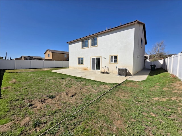 rear view of property featuring stucco siding, a lawn, a patio, a fenced backyard, and central AC unit