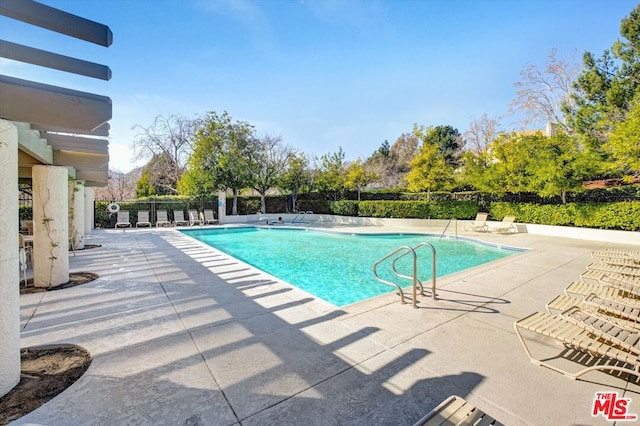 view of swimming pool with a patio area