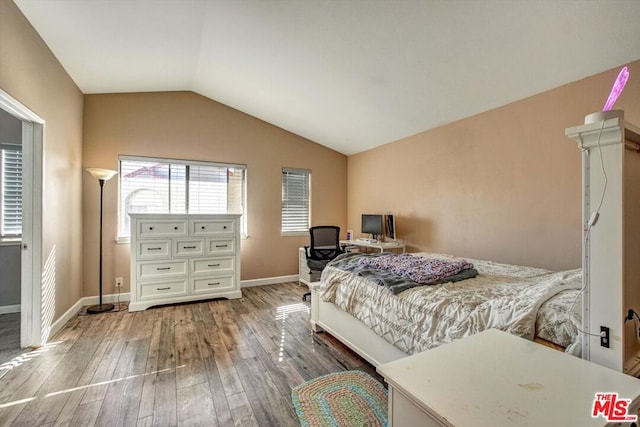 bedroom featuring wood-type flooring and vaulted ceiling