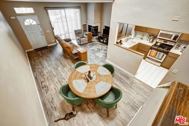 interior space featuring a tiled fireplace and light hardwood / wood-style floors