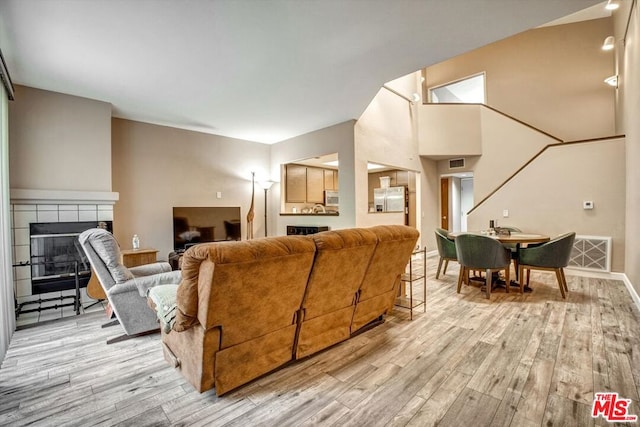 living room featuring a fireplace and light hardwood / wood-style floors