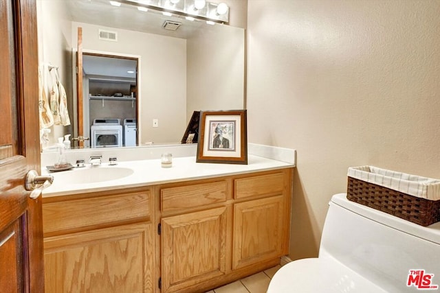 bathroom featuring tile patterned flooring, vanity, and toilet