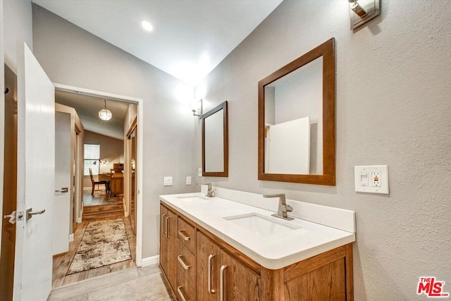 bathroom with vanity and vaulted ceiling