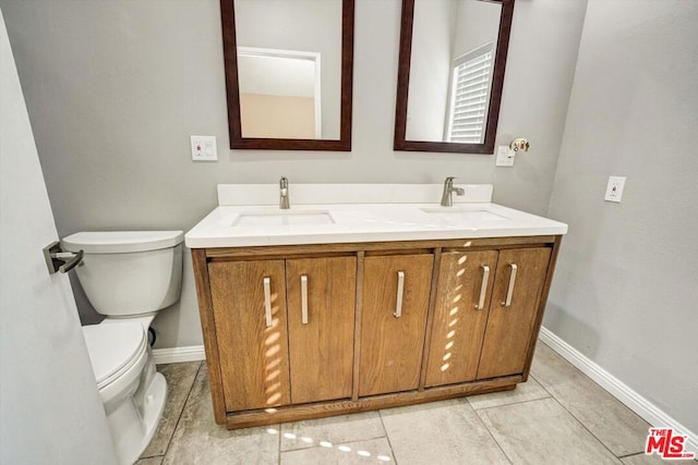 bathroom featuring tile patterned flooring, vanity, and toilet