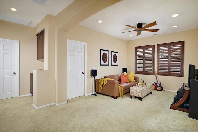 sitting room featuring light carpet and ceiling fan