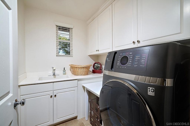 laundry room with cabinets, washer / dryer, sink, and light tile patterned floors