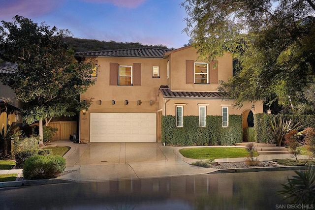 mediterranean / spanish home with a garage