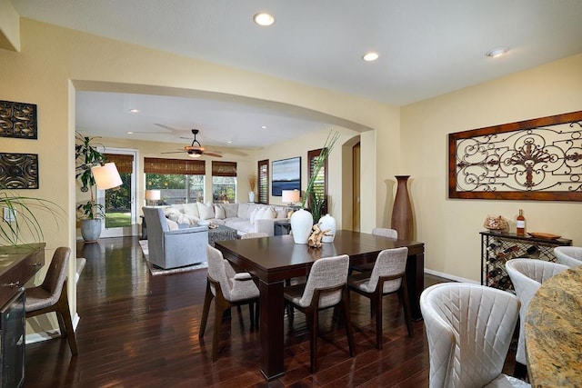 dining area with dark wood-type flooring and ceiling fan