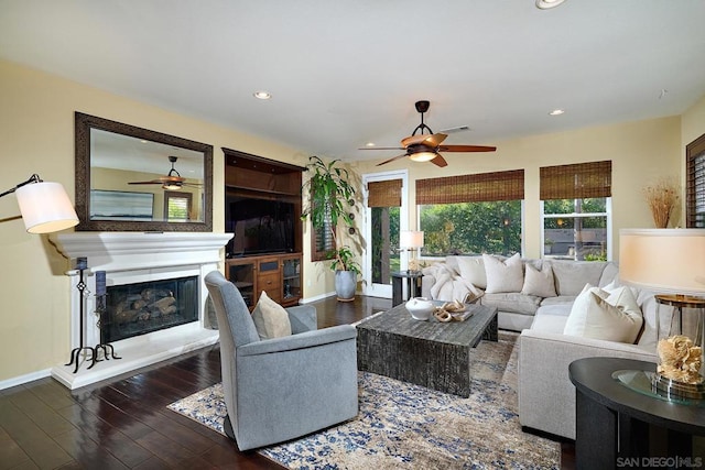 living room with dark wood-type flooring and ceiling fan