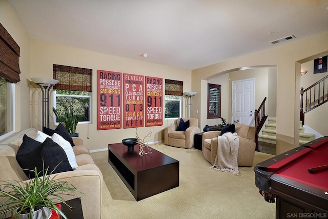 living room featuring billiards, light carpet, and a wealth of natural light