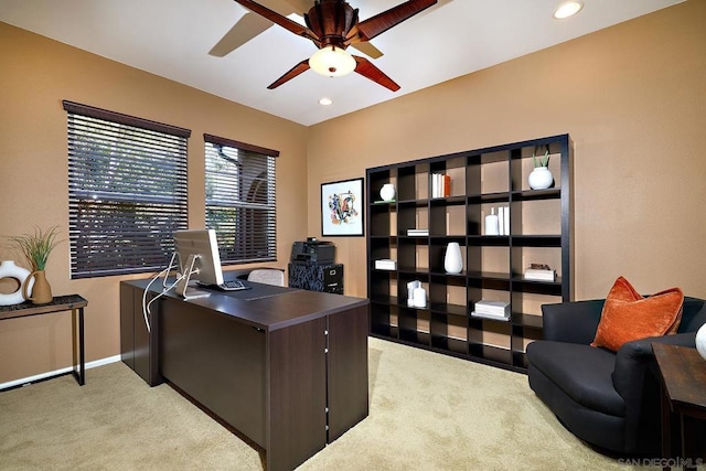 office space featuring light carpet and ceiling fan