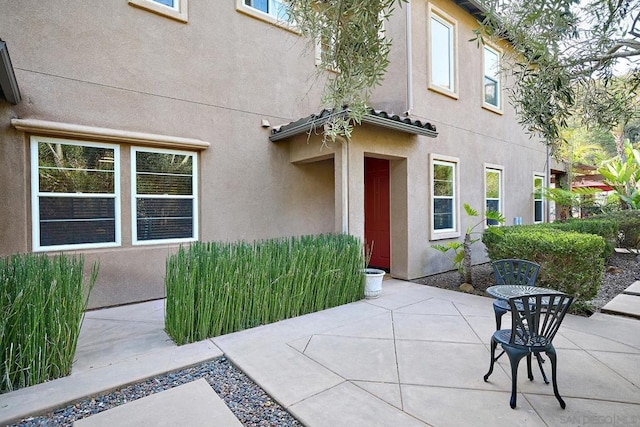 doorway to property with a patio area