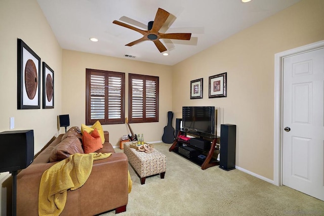 carpeted living room featuring ceiling fan