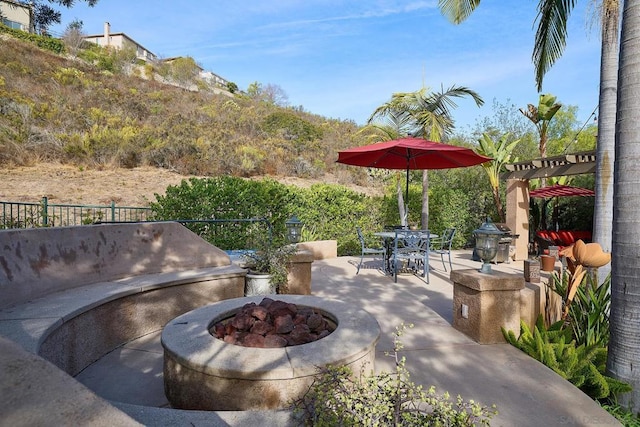 view of patio / terrace with a pergola, a grill, and a fire pit