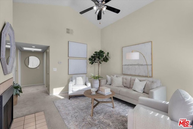 carpeted living room featuring high vaulted ceiling and ceiling fan