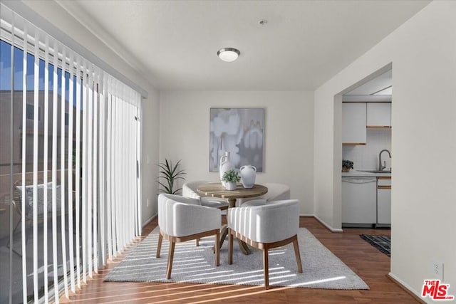 dining area featuring wood-type flooring and sink