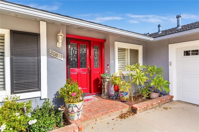 doorway to property with a garage